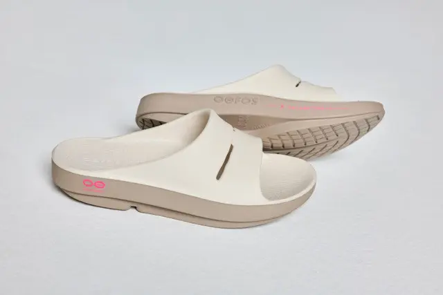Picture of a pair of white slides with pink details