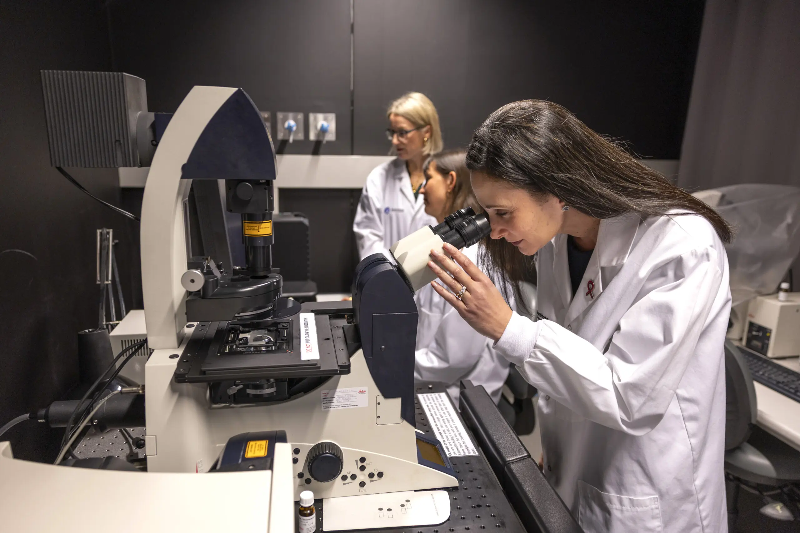 Image of a woman looking into a microscope