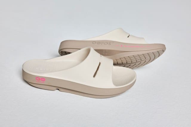Picture of a pair of white slides with pink details