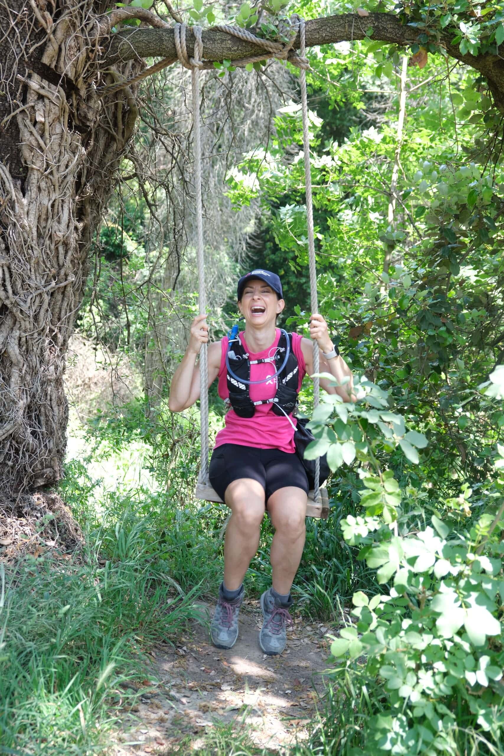Picture of a woman on a swing smiling