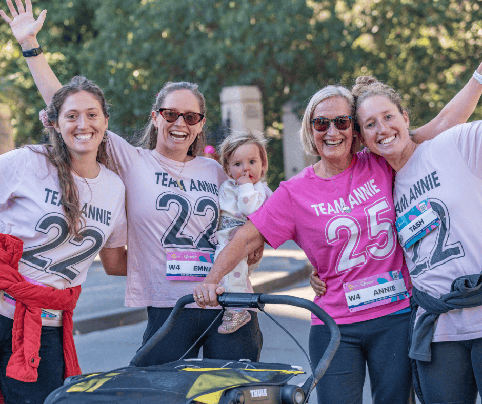 A family of five smiling doing a fun run