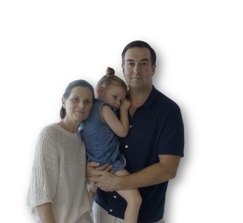 A photo of a mother and father holding their daughter