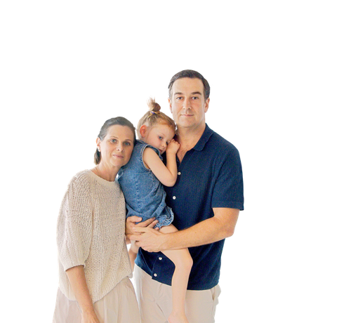 A photo of a mother and father holding their daughter