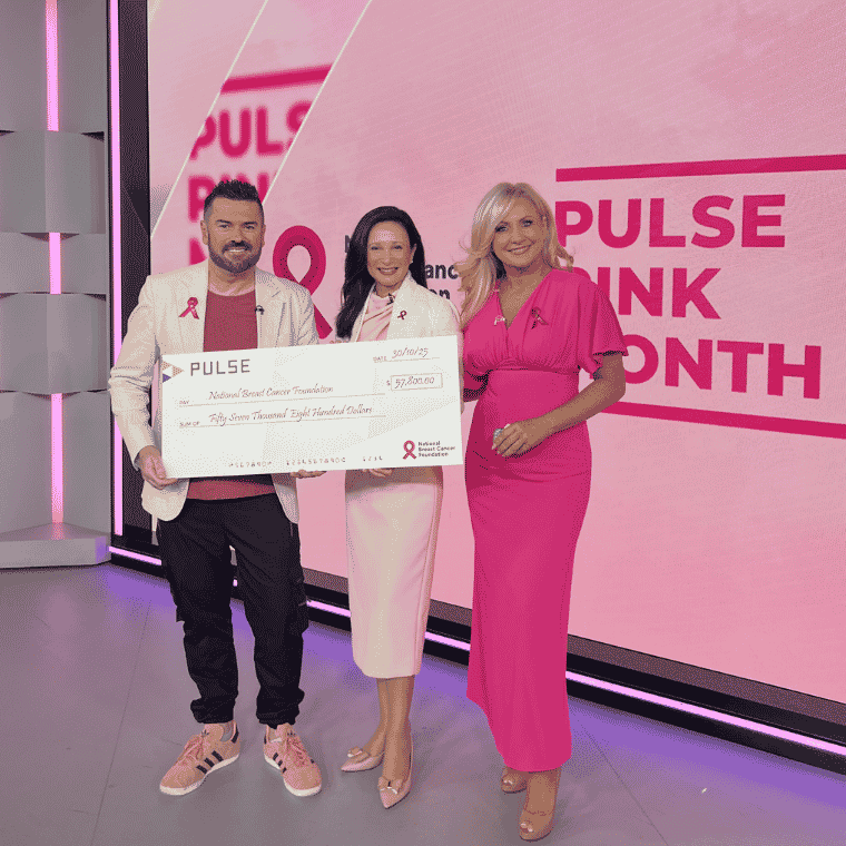 Image of a man and two women holding a big paper cheque